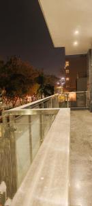 a bench on top of a building at night at Hotel Aroma Residency Premium Sector 47 Family Friendly in Gurgaon