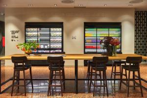 a restaurant with a large wooden table and chairs at Quark Hotel Milano in Milan