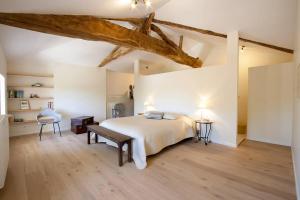 a large bedroom with a bed and a chair at Domaine borgnette fantastique maison in Moulidars +50 photos