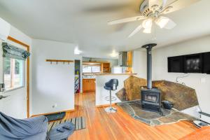 a living room with a wood stove in it at Clark Fork Vacation Home with Wood Stove Near Lake! in Clark Fork