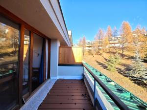 a balcony of a house with a view of the mountains at Hostdomus - Sansicario R8 in San Sicario