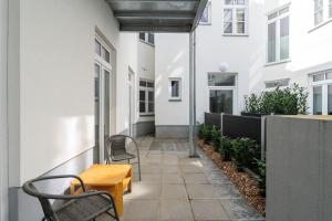 a patio with two chairs and a wooden table at HM • Cosy 1BR Near Westbahnhof in Vienna