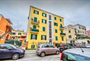 a group of cars parked in front of a yellow building at Begonie House in Rome