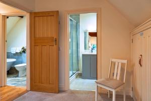 a bathroom with a toilet and a sink and a door at Finest Retreats - Lower School Cottages in Minehead +19 photos