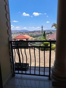 a room with a balcony with a view of a city at Green Valley in Kigali