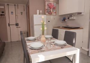 a kitchen with a table with plates and dishes on it at Ale&Anda in Trani
