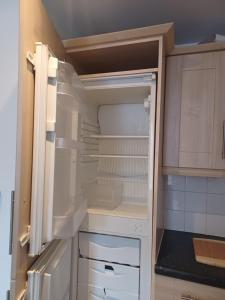 an empty refrigerator with its door open in a kitchen at Q Flat Skyview Spacious in Bradford