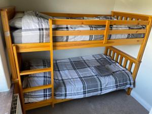 two bunk beds in a room with a bed at The Leavesley in Blackpool