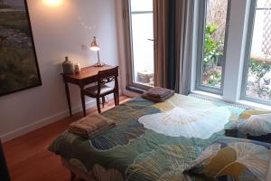 a bedroom with a bed and a desk and a window at Chambre d'ALO in Clamart