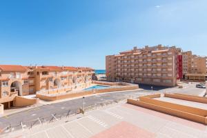 an aerial view of a city with buildings and a street at URBANIZACIÓN COPACABANA - La Manga del Mar Menor KM2 - Vistas a Mediterráneo Dormitorio doble y sofá-cama in La Manga del Mar Menor