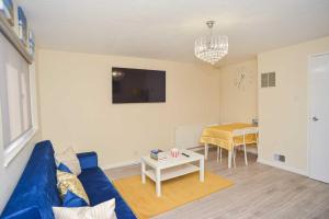 a living room with a blue couch and a table at London's Calling You! 2 Bed Lovely Home Sleeps 1-5! in Thamesmead