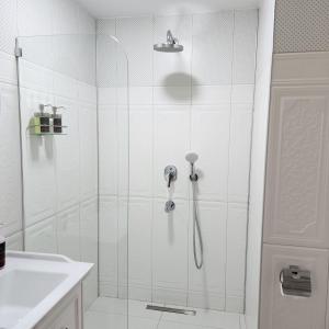 a shower with a glass door in a bathroom at Pertevniyal Aziziye Hotel in Konya