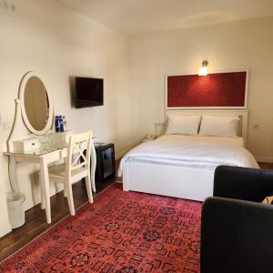 a bedroom with a bed and a desk and a mirror at Pertevniyal Aziziye Hotel in Konya