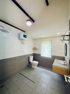 a bathroom with a toilet and a shower at Eleven villa 2 in Pangandaran