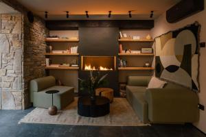 a living room with a couch and a fireplace at Slow Tatry Boutique Resort in Zakopane