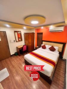 a bedroom with a bed with an orange wall at Trekkers Home in Kathmandu