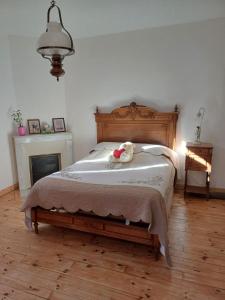 a bedroom with a bed with a stuffed animal on it at E lu chantauziau in La Monnerie-le Montel