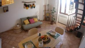 a living room with a table and a couch at La Casina di Chloe in Livorno