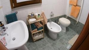 a bathroom with a white toilet and a sink at La Casina di Chloe in Livorno +23 photos