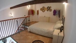 a bedroom with a bed and a staircase in a room at La Casina di Chloe in Livorno