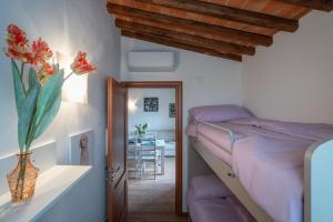 a bedroom with a bed and a dining room at Casa d'Orcia in Pienza