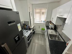 a small kitchen with a sink and a stove at Aldgate East Rooms R1 in London