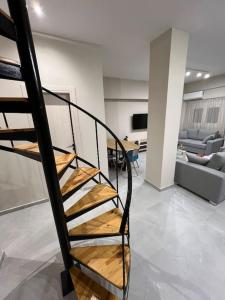 a spiral staircase in a living room with a couch at Melisa in Piraeus