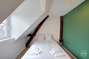a bed in a attic with two pillows on it at Le Connemara / Plumereau in Tours