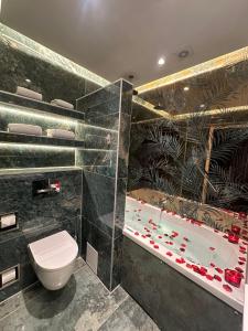 a bathroom with a toilet and a bath tub at Alp Hotel in Amsterdam