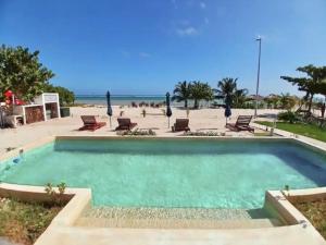 a swimming pool with a view of the beach at Condos Azul Azul Mahahual in Mahahual