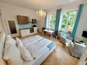 a bedroom with a large bed and a living room at The Cozy Lindau No 2 in Lindau