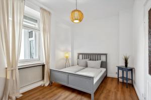 een witte kamer met een bed en een raam bij Wunderschönes 4 Zimmer Altbau Apartment mit Terrasse und Patio in Wuppertal