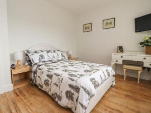 a bedroom with a bed and a desk and a television at 14 Berwick Road in Lytham St Annes