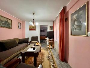 a living room with a couch and a table at Verica in Vračar (historical)