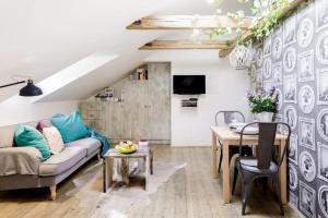 a living room with a couch and a table at Romantic Bohemian Studio in Old Town Prague in Prague