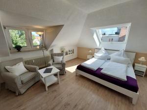 a bedroom with a bed and a couch and a chair at The Cozy Lindau No 3 in Lindau +6 photos