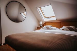 a bedroom with a large mirror and a bed at VAGABONDO PETIT MAISON in Caserta