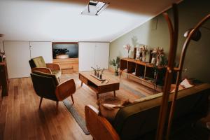 a living room with a couch and chairs at VAGABONDO PETIT MAISON in Caserta