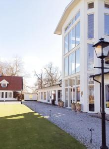 a white building with a street light in front of it at Elisefarm in Fogdarp