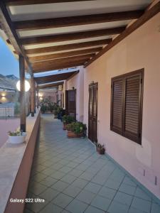 a balcony of a house with potted plants at Casa Sabrina in San Vito lo Capo