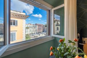 a window with a view of a city at New Morpheus Rooms in Rome