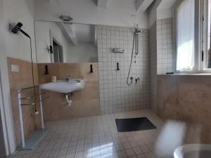 a bathroom with a sink and a shower at AURUM Affittacamere in Loreto +31 photos