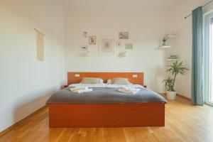 a bedroom with a bed with two towels on it at VILA KLARA apartments in Ljubljana