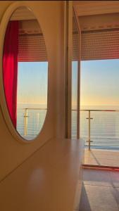 a room with a large window with a view of the ocean at holiday shengjin kozmai in Shëngjin