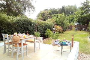 a table and chairs sitting on a patio at Quiet Devon Luxury Escape 3-Bed in Honiton