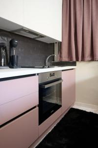 a kitchen with a sink and an oven in it at 2024 superior modern studio! in Mytilene