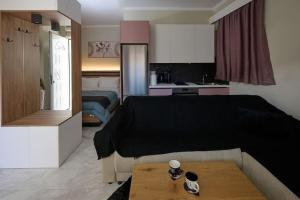 a hotel room with a bed and a kitchen at 2024 superior modern studio! in Mytilene