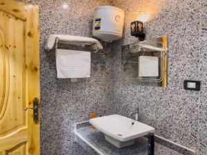 a bathroom with a sink and a towel dispenser at Live pyramids in Cairo