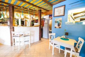 a restaurant with a table and chairs and a bar at Motel Te Klimaty in Czeladź