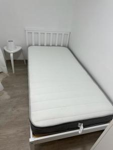 a mattress on a bed frame in a room at Single ensuite room in London
